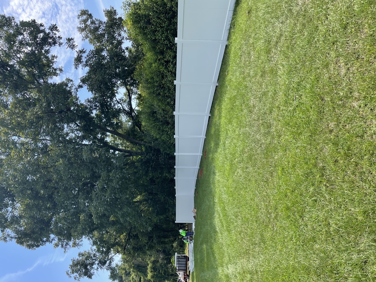 Vinyl fence installation Columbia SC — day 2, working under tree canopy